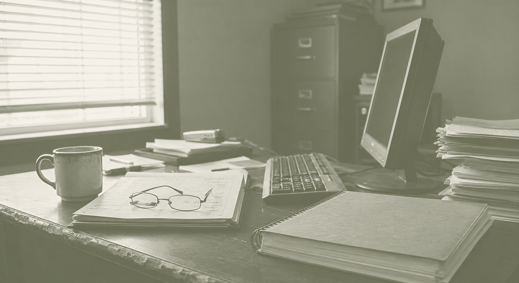 Owner's desk, duotone olive and cream.
